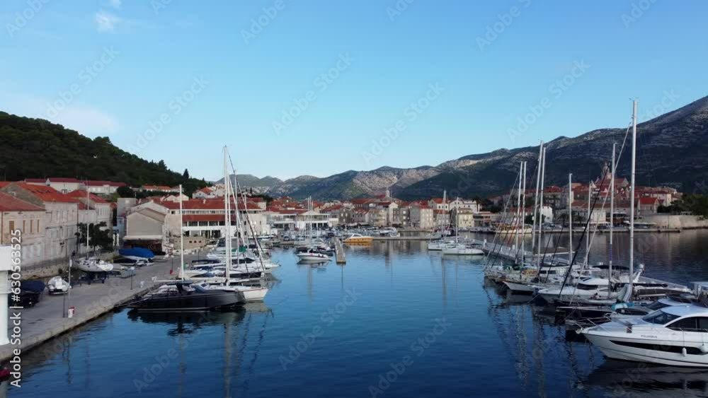 Harbour and boats in the island of Korcula in Adriatic sea, Medieval houses in the background, Croatia Harbour and boats in the island of Korcula in Adriatic sea, Medieval houses in the background, Croatia