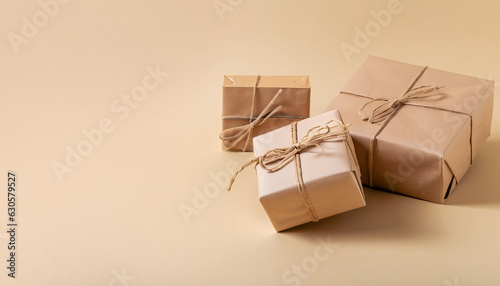 Gifts in eco-friendly paper packaging on a trendy beige background. Layout mockup copy space concept minimalism