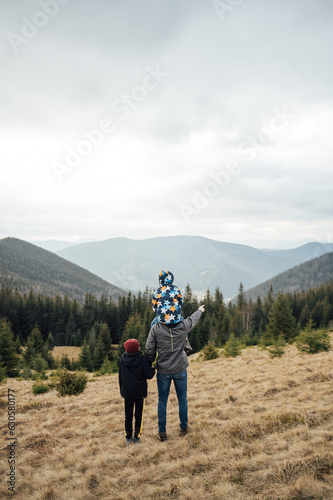 Two Brother boys stand at the top of the mountain. Ukrainian Carpathians photo