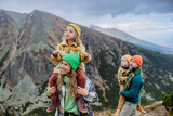 Happy family hiking together in autumn mountains.