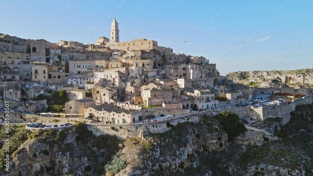 Aerial view of ancient city Matera, Italy. Late afternoon, tourists walking, balloon flying in the background. Aerial view of ancient city Matera, Italy. Late afternoon, tourists walking, balloon flying in the background.