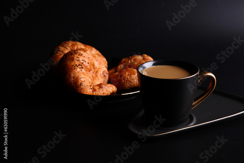 Fototapeta Naklejka Na Ścianę i Meble -  Hot latte coffee with Croissant coffee break isolated in black background