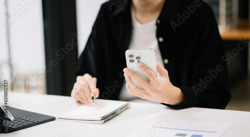 businessman working with digital tablet computer and smart phone with financial business strategy layer effect on desk