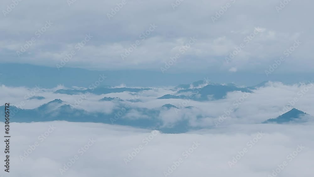 Mountain range with visible silhouettes through the morning colorful fog.