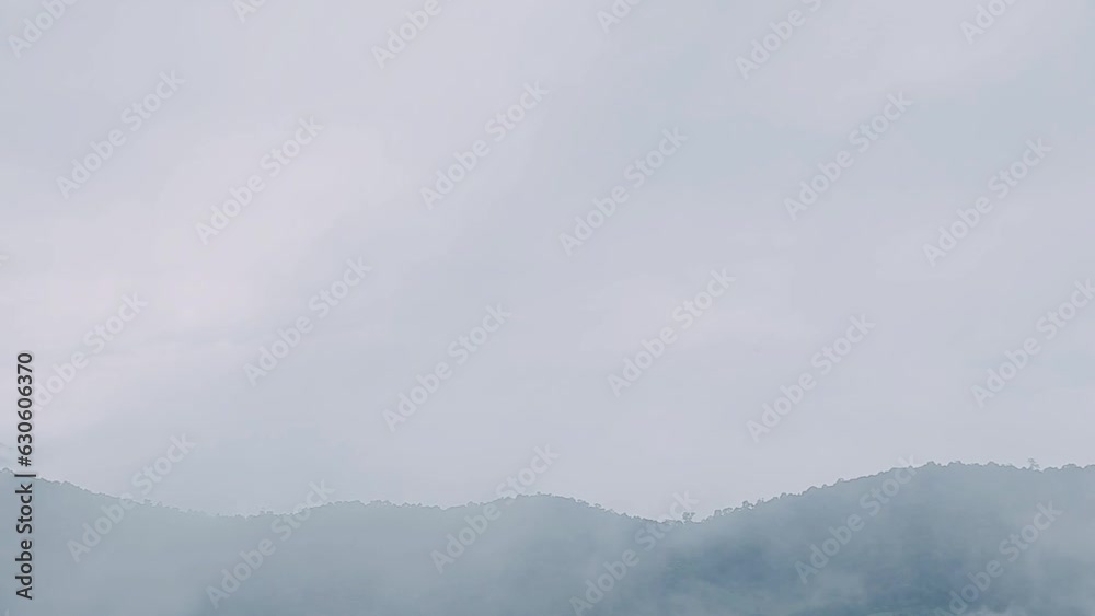 Mountain range with visible silhouettes through the morning colorful fog. Mountain range with visible silhouettes through the morning colorful fog.