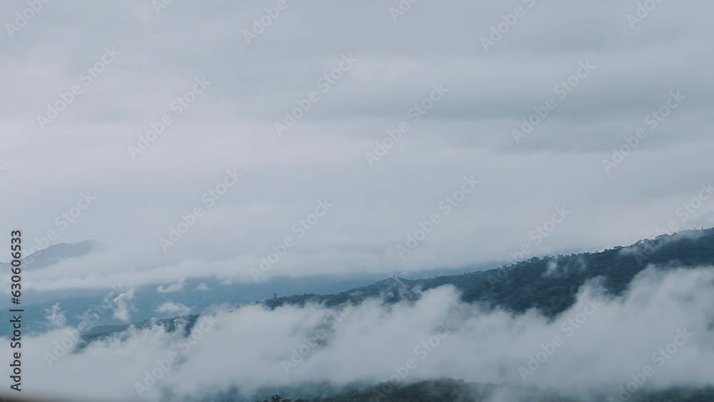 Mountain range with visible silhouettes through the morning colorful fog. Mountain range with visible silhouettes through the morning colorful fog.