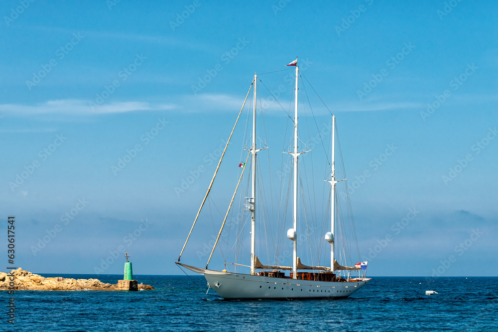 luxury sailing yacht entering a harbour in the Mediterranean Sea