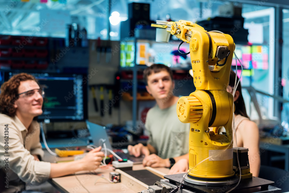 Group of young people doing experiments in robotics in a laboratory
