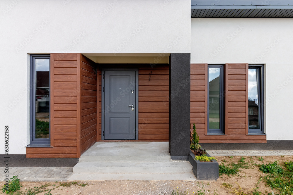 View of a small modern house immediately after construction. Step house construction system View of a small modern house immediately after construction. Step house construction system