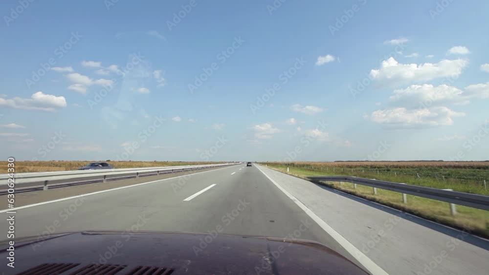 Car using left lane overtaking cars on the right at motorway at sunny