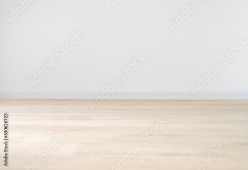 Beige oak floor and light wall for room background design. The concept of a mockup of empty space in an apartment.