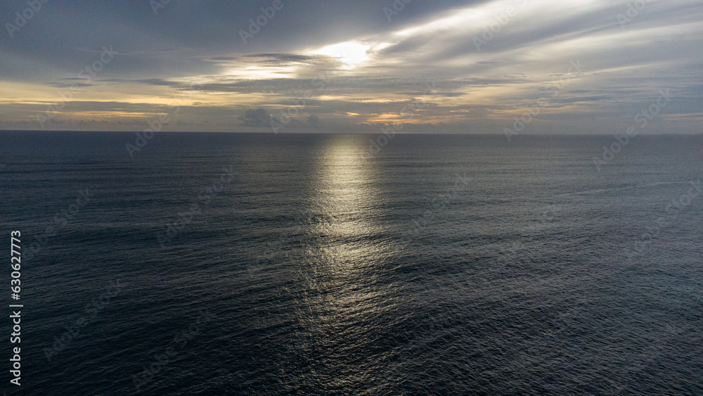 Obraz premium Cinematic aerial view of sunset waves off the coast of Aceh, Indonesia.