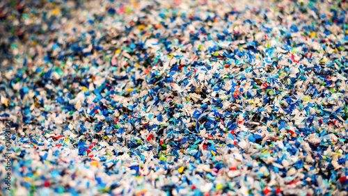 Shredded plastic garbage at waste recycling factory photo