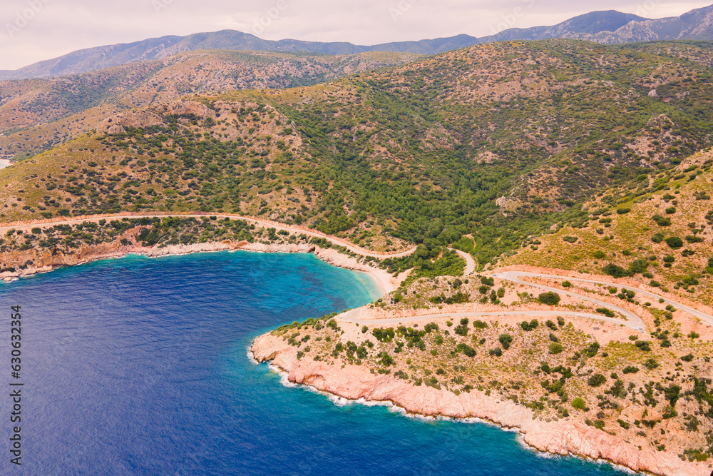 Scenic winding road between hills and sea coastal landscape, aerial shot