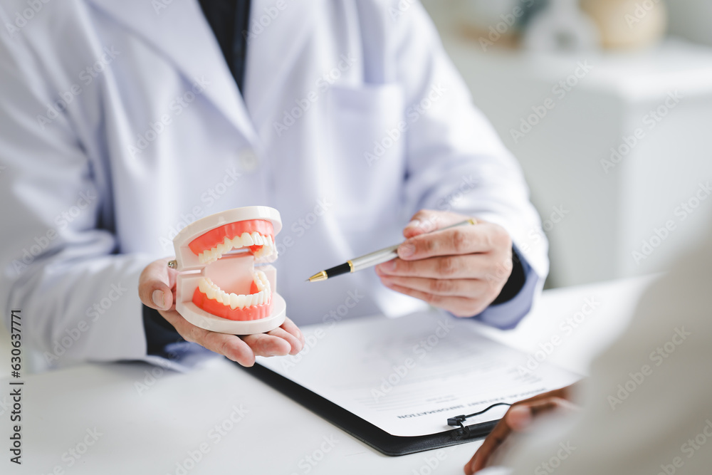 Dentist explaining endodontic treatment to patient in office Dentist