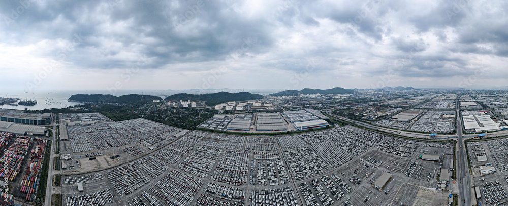 Aerial view by drone Landscape Panorama view, lots of new cars awaiting export at the shipping port.