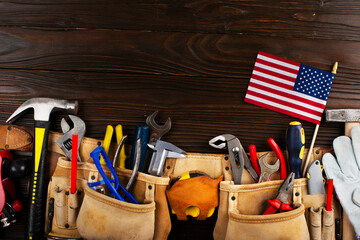 Labor day banner mockup of tools toolbelt and us flag on wooden background