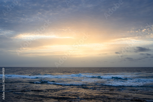 sunset over the Atlantic ocean with calm waves