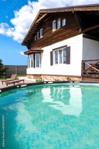 Private blue frame swimming pool near the house. Sunny summer vacation © lelechka