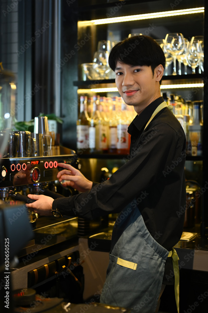 Smiling male barista preparing coffee for customer order in trendy coffee. Small business concept.