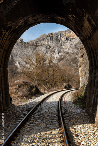 Old railway passing through short tunnels in picturesque rural scenery 