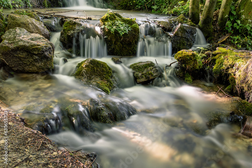 Serene Cascading River Amidst Vibrant Autumn Landscape