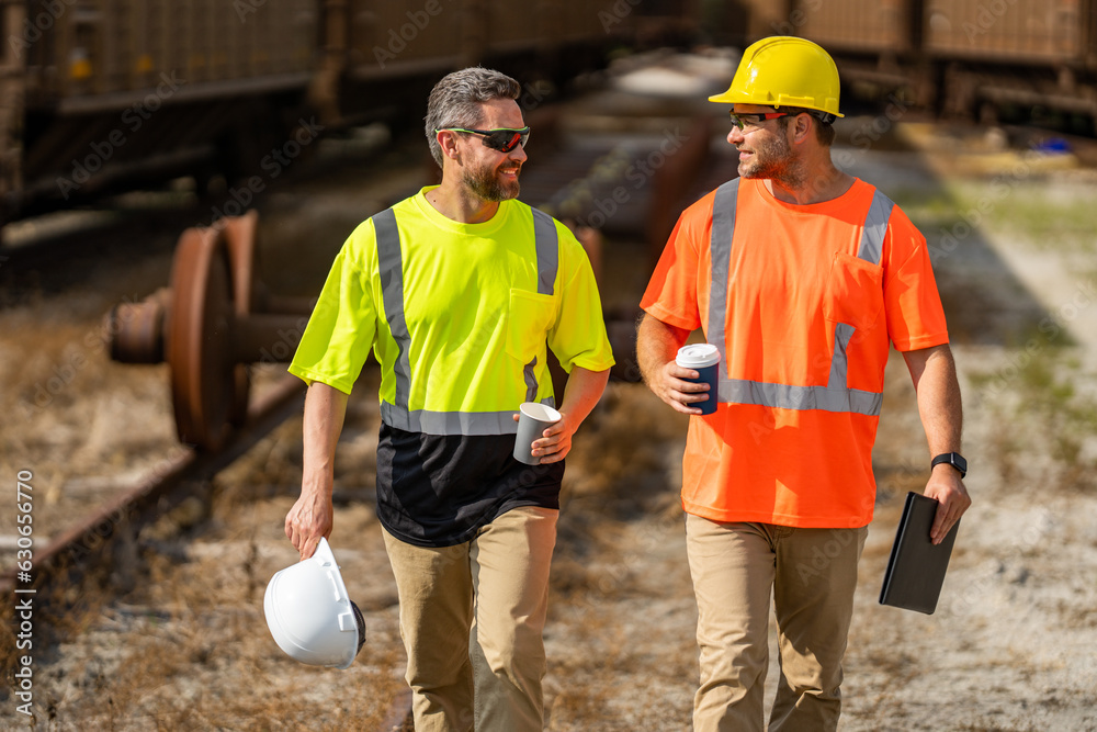 Builders on the job. Two builders in a hard hat at construction site