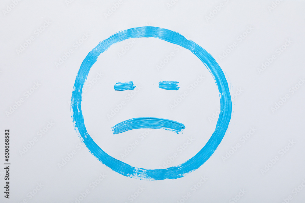 Blue sad emoji on white background, top view Blue sad emoji on white background, top view