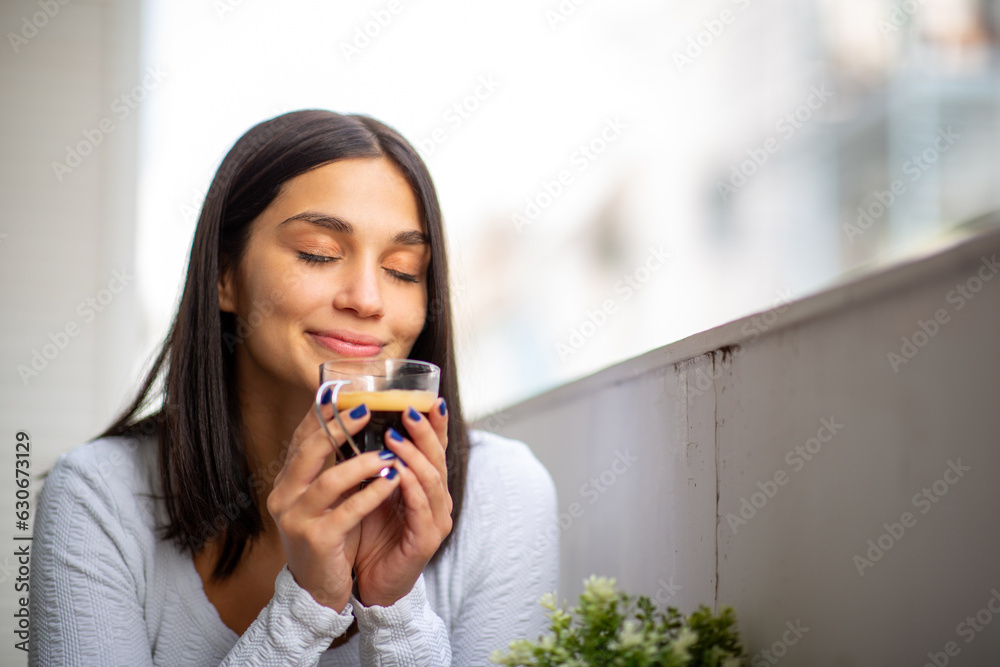 Young woman enjoying cup of coffee Young woman enjoying cup of coffee