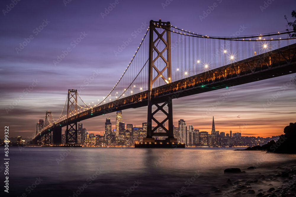San Francisco-Oakland Bay Bridge and city skyline at sunset in California, USA