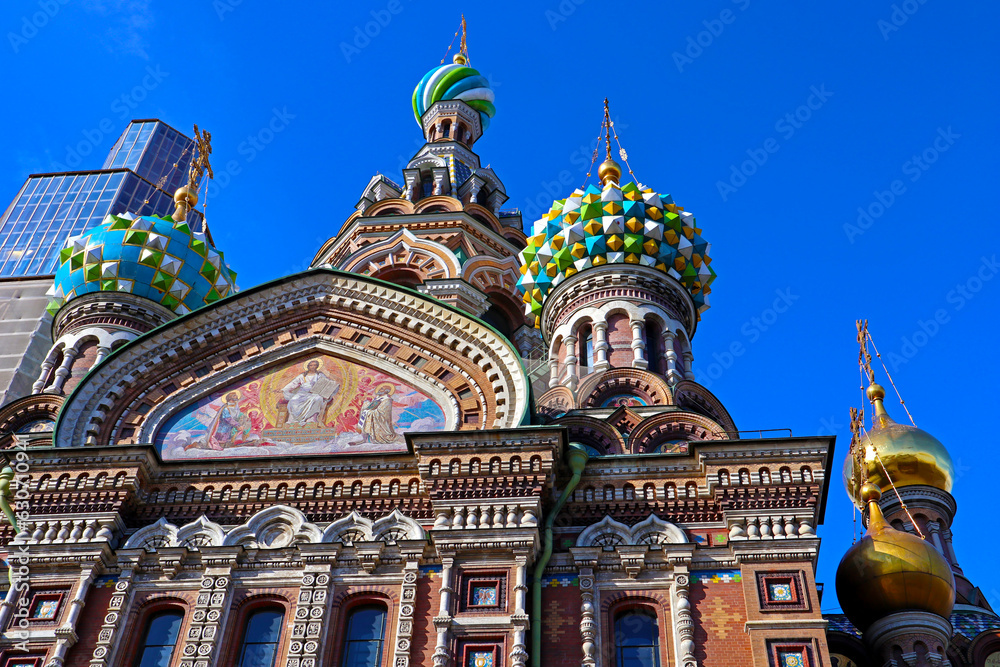 Exterior of Church of the Savior on Blood with ornate domes against blue sky. Outside view of architecture of famous Russian Temple and museum. Saint Petersburg, Russia.