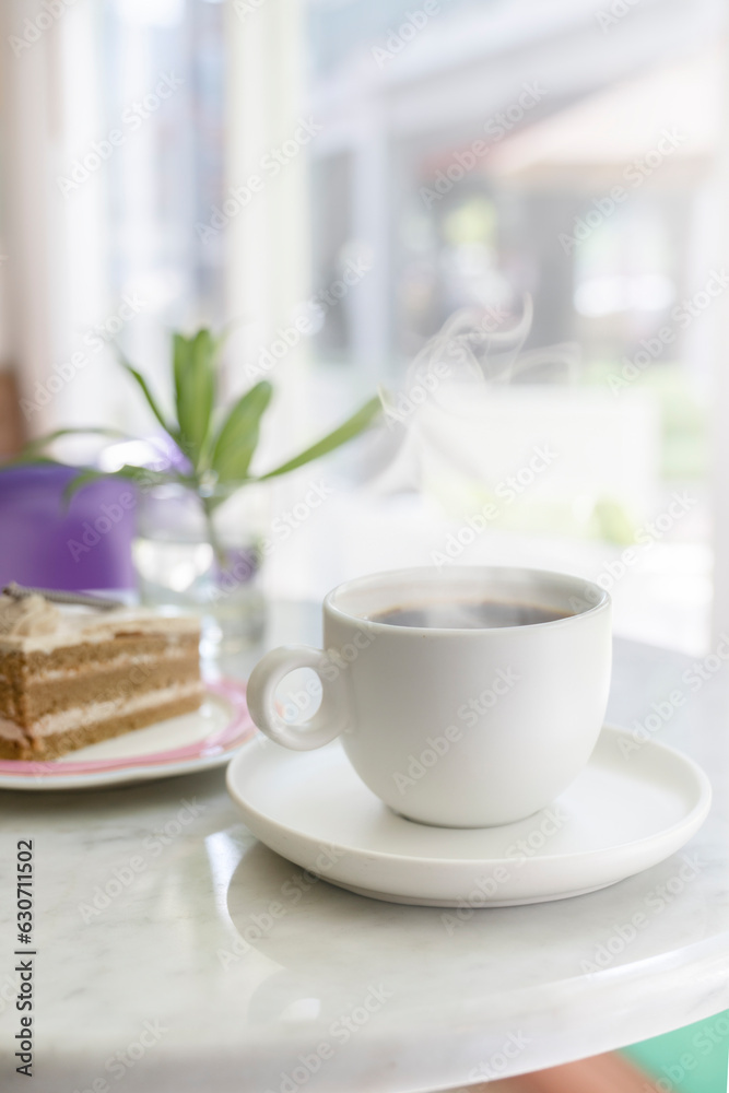 Coffee break. A mug of hot steaming coffee on the table, next to a cake. concept for a coffee shop Coffee break. A mug of hot steaming coffee on the table, next to a cake. concept for a coffee shop