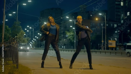Couple of dancers dancing high heels dance on night city streets. Urban movements and the rhythm of the music of the streets of the city in dance. High quality 4k footage