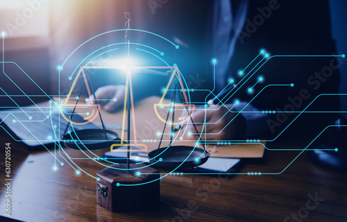 Justice and law concept.Male judge in a courtroom with the gavel, working with, computer and docking keyboard, eyeglasses, on table in morning light