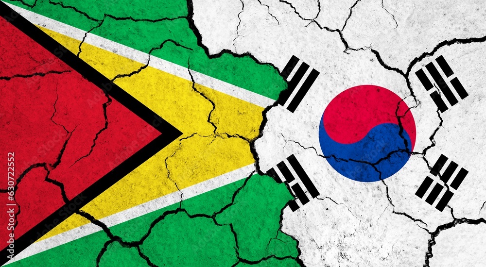 Flags of Guyana and South Korea on cracked surface - politics, relationship concept