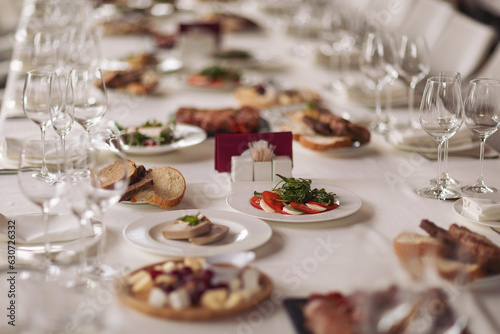 Catering service. Restaurant table with food. Huge amount of food on the table. Plates of food. Dinner time  lunch. Appetizers table with different antipasti  charcuterie  snacks  cheese  salad  pate.