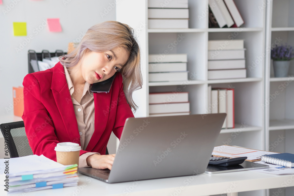 Busy businesswoman at work and talking on the phone looking at laptop screen Frustrated young woman arguing with customer holding a smartphone and being stressed solve business problems. Busy businesswoman at work and talking on the phone looking at laptop screen Frustrated young woman arguing with customer holding a smartphone and being stressed solve business problems.