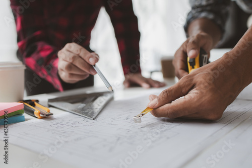 Fotografija The home design architects are reviewing the house plan draft, the project commissioned by the client, and the custom design before delivery