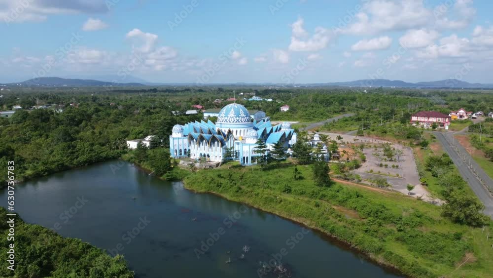 Aerial The Nurussalam Mosque in the Tanah Bumbu district, the Gunung Tinggi office area, has a beautiful view, located near a lake and mountains Aerial The Nurussalam Mosque in the Tanah Bumbu district, the Gunung Tinggi office area, has a beautiful view, located near a lake and mountains