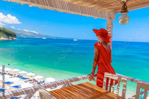 the tranquil beauty of Pulebardha beach in Albania. A girl enjoys the beautiful aerial view and relaxes amidst the majestic landscape which makes it the perfect vacation location.