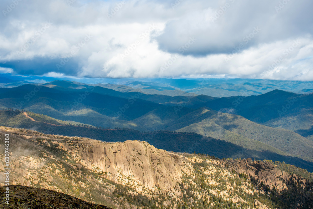 Mount Buffalo National Park, Victoria. Australia. Australian Alps views from The Horn picnic area. Mountains and clouds scenic view Mount Buffalo National Park, Victoria. Australia. Australian Alps views from The Horn picnic area. Mountains and clouds scenic view