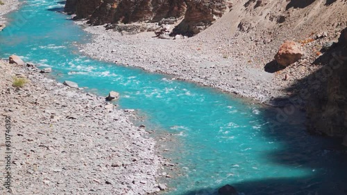 Blue Tsarap chu river flowing in the mountain valley of Zanskar as seen during the trek to Phugtal Monastery from Purne in Zanskar Valley, Ladakh, India. Beautiful blue river flowing in the Himalayas. photo