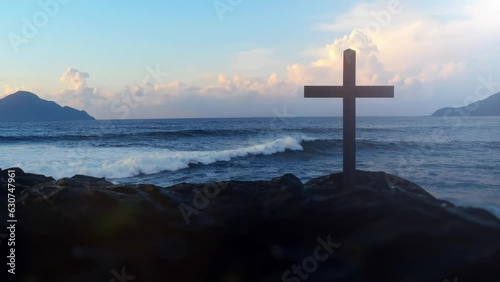 Christ Cross on an island in the middle of the open sea. Looping animation concept for faith, power, worship, christianity and easter