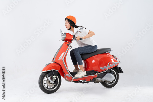 full body photo of a woman wearing a hairdresser and driving a motorbike