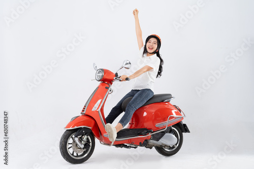 full body photo of a woman wearing a hairdresser and driving a motorbike