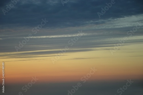 Beautiful natural sunrise, sunset against a dark blue sky with an orange stripe. Abstract background.