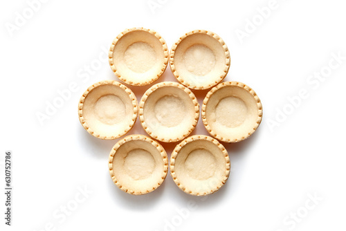 Unfilled tartlet shells isolated on white background, top view. Seven crispy mini tart shells for portable desserts. Empty tartlet cups, a canvas for flavorsome combinations photo