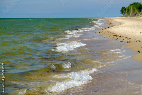 Fototapeta Naklejka Na Ścianę i Meble -  The sandy shore of the Baltic Sea. Wide coastal area and dunes.