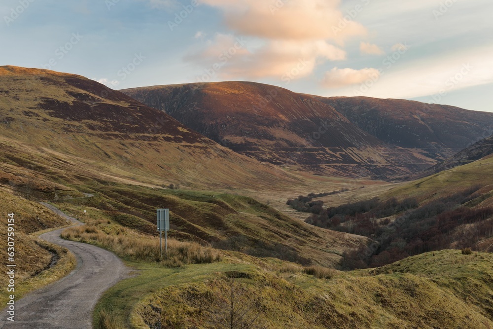 Scenic view of winding roads leading through the Glen Roy Valley in Scotland vanish at sunset