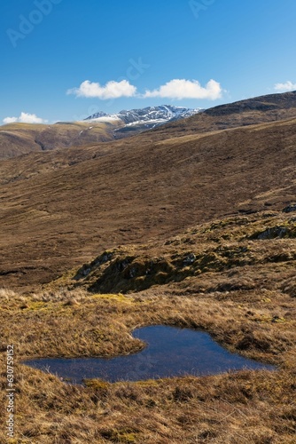 Scenic view of a heart-shaped puddle with a snow-capped mountain in the distance © Iain D Nicholl/Wirestock Creators